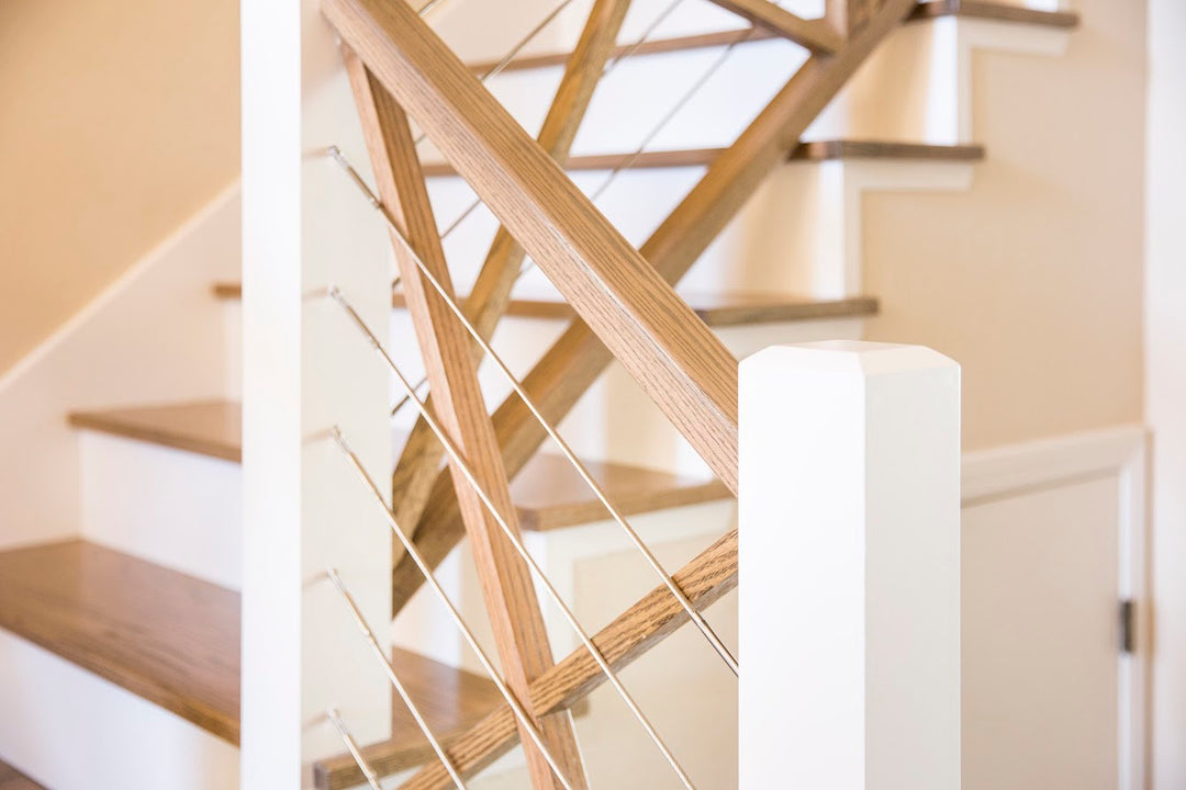 Wooden staircase with beveled newel in a home interior.