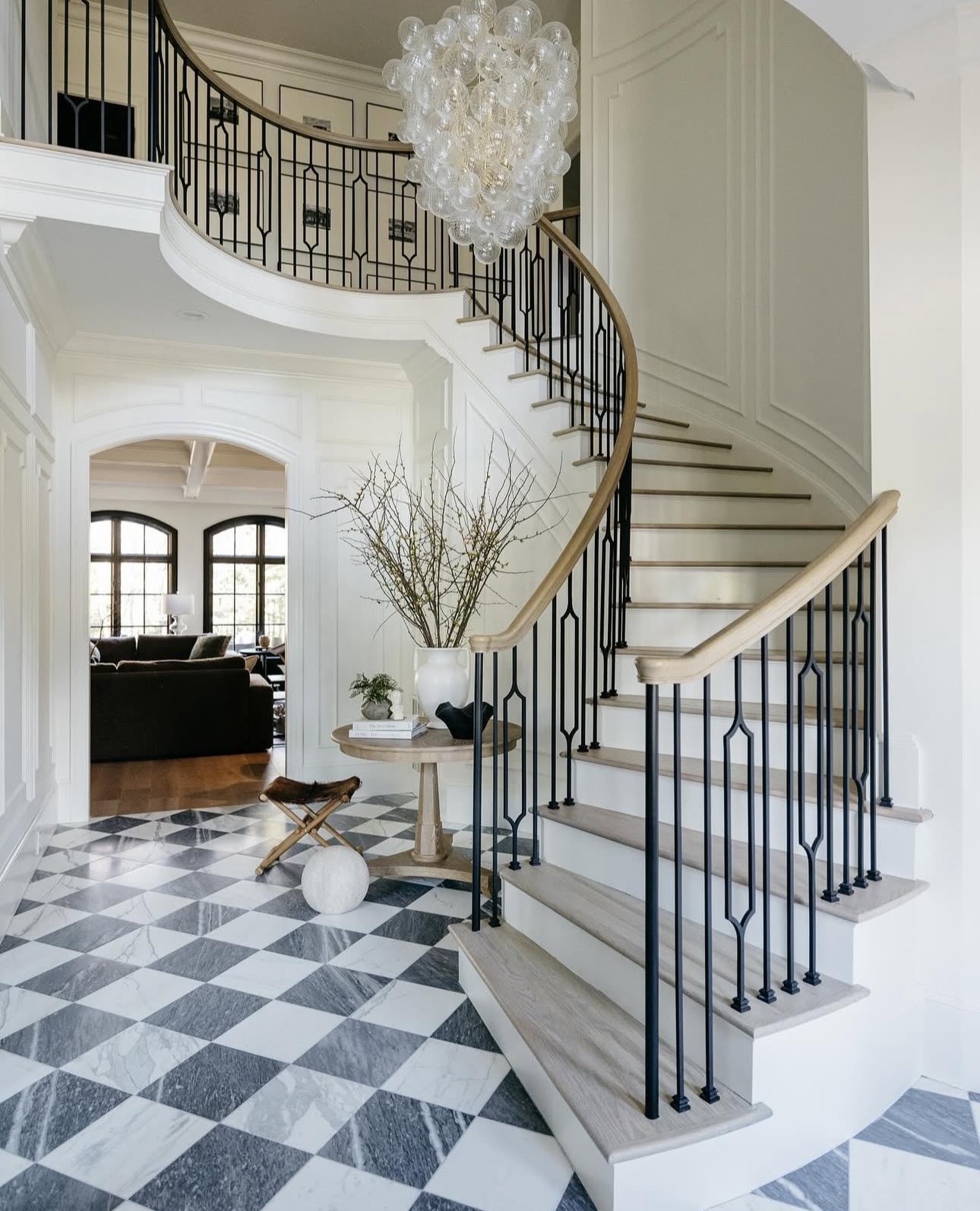 Traditional Staircase with black railings and white steps in a home interior.